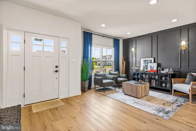 a living room with furniture window and wooden floor