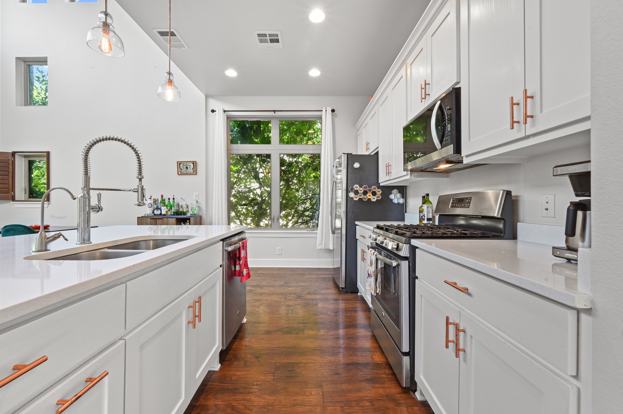 592 Farm To Market 967, Unit B Buda, TX 78610 - Photo 7 of 26 Bright, stylish, and designed for everyday living, this beautifully appointed kitchen offers abundant cabinetry, generous counter space, and an effortless flow into the surrounding living areas.