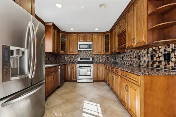 a kitchen with stainless steel appliances a stove sink microwave and cabinets