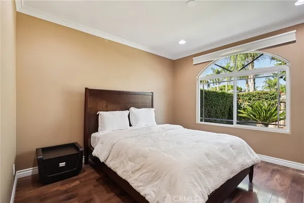 a large bed sitting in a bedroom next to a wall