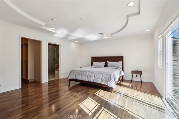 a bedroom with a large bed and a large window