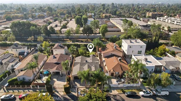 an aerial view of residential houses with city view