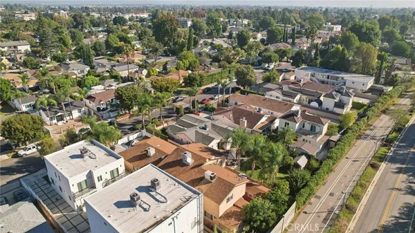 an aerial view of residential houses with outdoor space