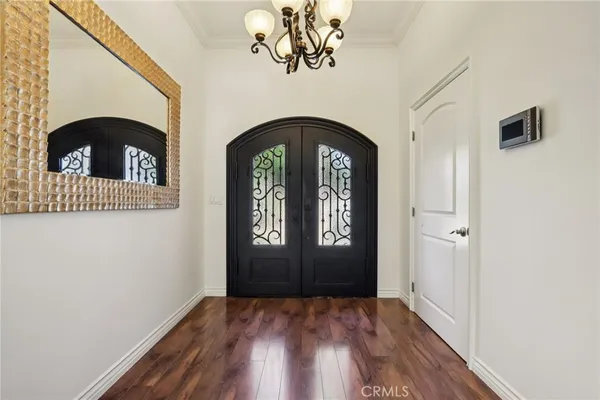 a view of a entryway door with wooden floor