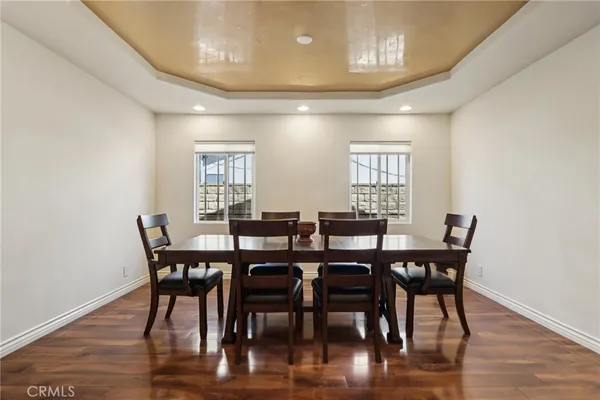 a view of a dining room with furniture and wooden floor