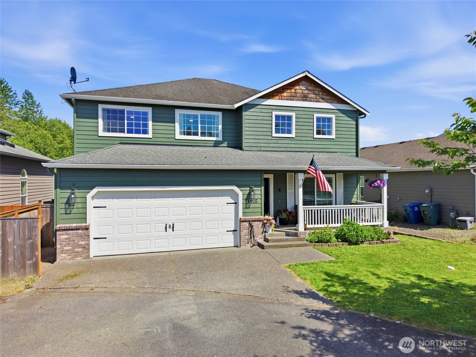 14005 Cedar Court Sultan, WA 98294 - Photo 2 of 38 a front view of a house with a yard and garage