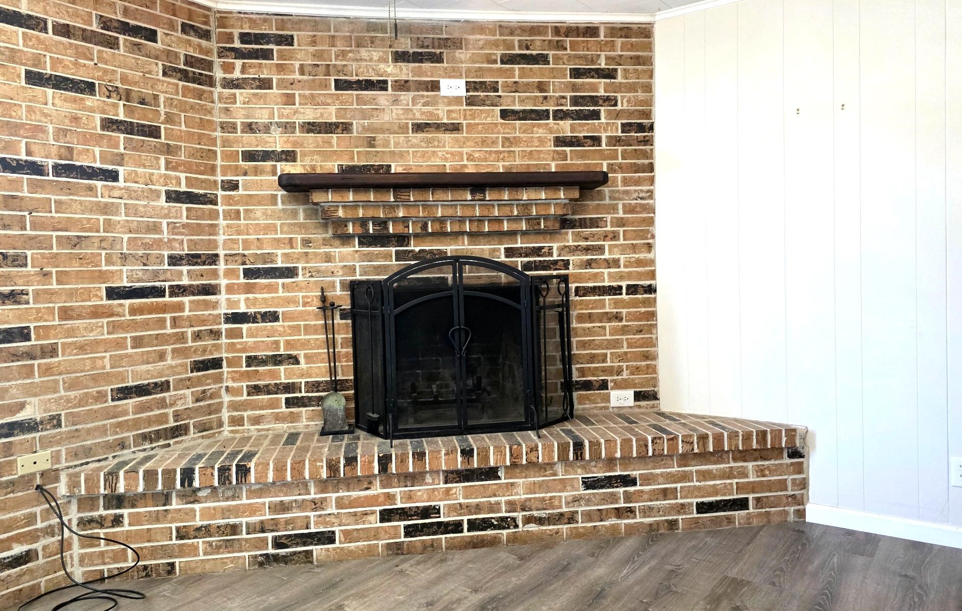 201 Verna Street Jasper, TX 75951 - Photo 4 of 24 The winter welcomes the cozy corner fireplace and wooden mantel. The fellowship around this beauty is priceless.