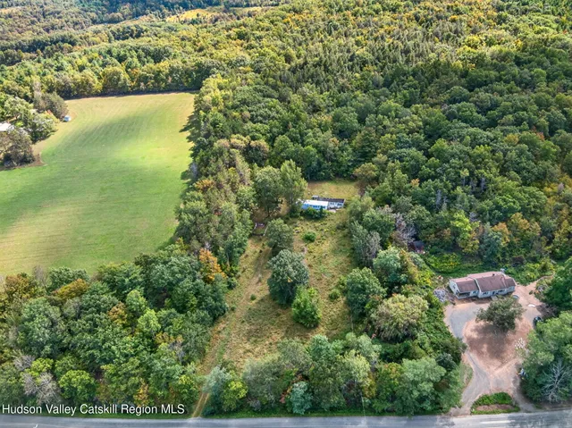 an aerial view of a houses with yard
