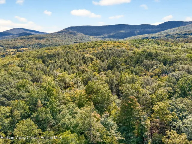 a view of a large mountain with a mountain in the background