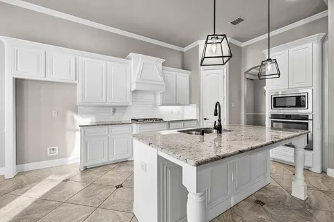 a kitchen with a sink window and cabinets