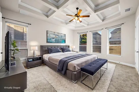 an empty room with windows and ceiling fan