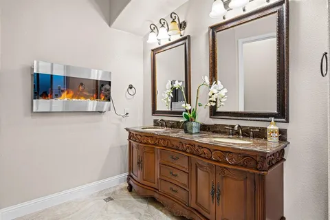 a bedroom with a large bed and a flat tv screen