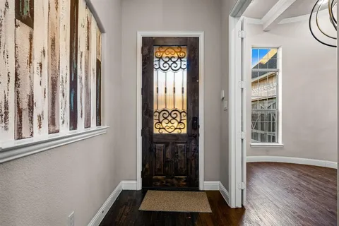 a view of front door with wooden floor