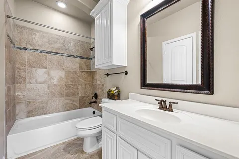 a patio with table and chairs and potted plants