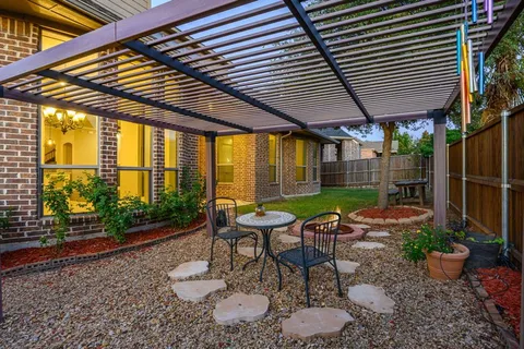 a view of a chairs and table in a backyard