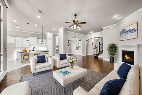 a view of a kitchen and an empty room with fire place