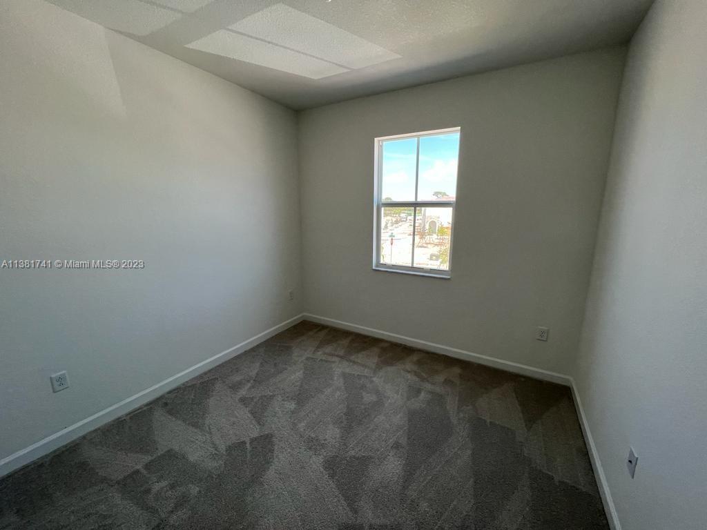12958 Northwest 23rd Place, Unit 12958 Miami, FL 33167 - Photo 18 of 23 an empty room with a window