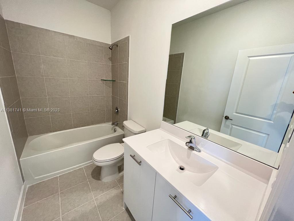 12958 Northwest 23rd Place, Unit 12958 Miami, FL 33167 - Photo 23 of 23 a bathroom with a sink a toilet and shower