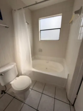 a bathroom with a toilet and a bathtub