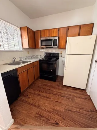 a kitchen with wooden floors and a sink