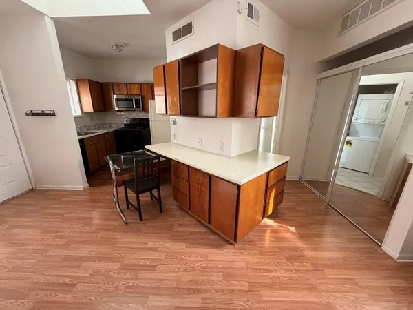 a living room with stainless steel appliances kitchen island granite countertop furniture and a fireplace