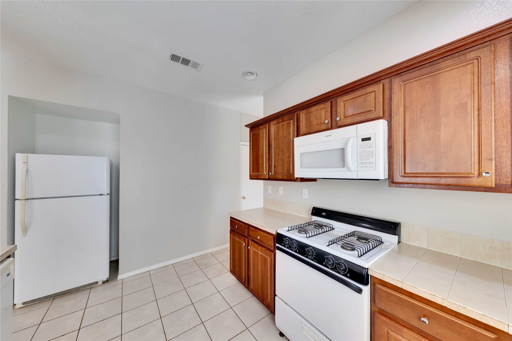 2201 East 18th Street, Unit B Austin, TX 78702 - Photo 7 of 25 A functional kitchen boasts ample cabinetry and essential appliances for daily living.