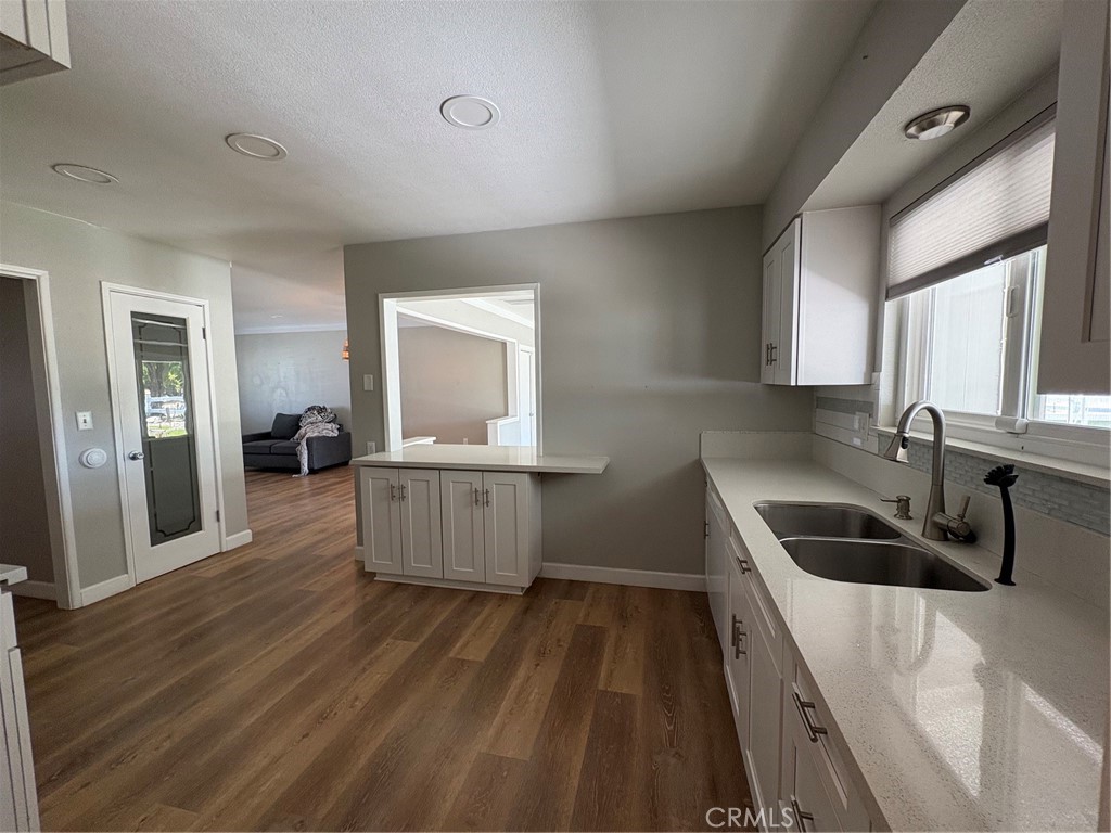 26378 Ridgemoor Road Menifee, CA 92586 - Photo 6 of 20 a kitchen with a sink and wooden floor