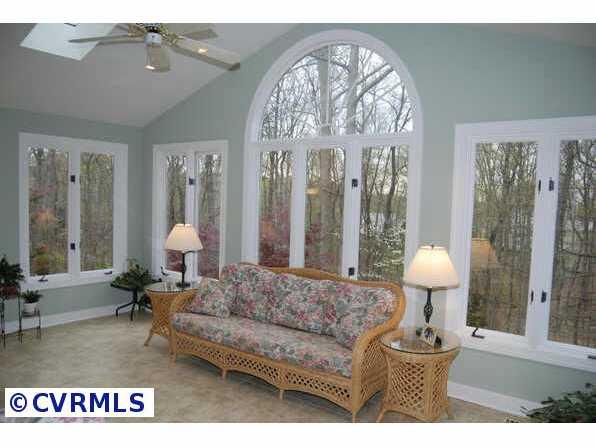 Other - Sun room featuring vaulted ceiling with ceiling fan and skylites