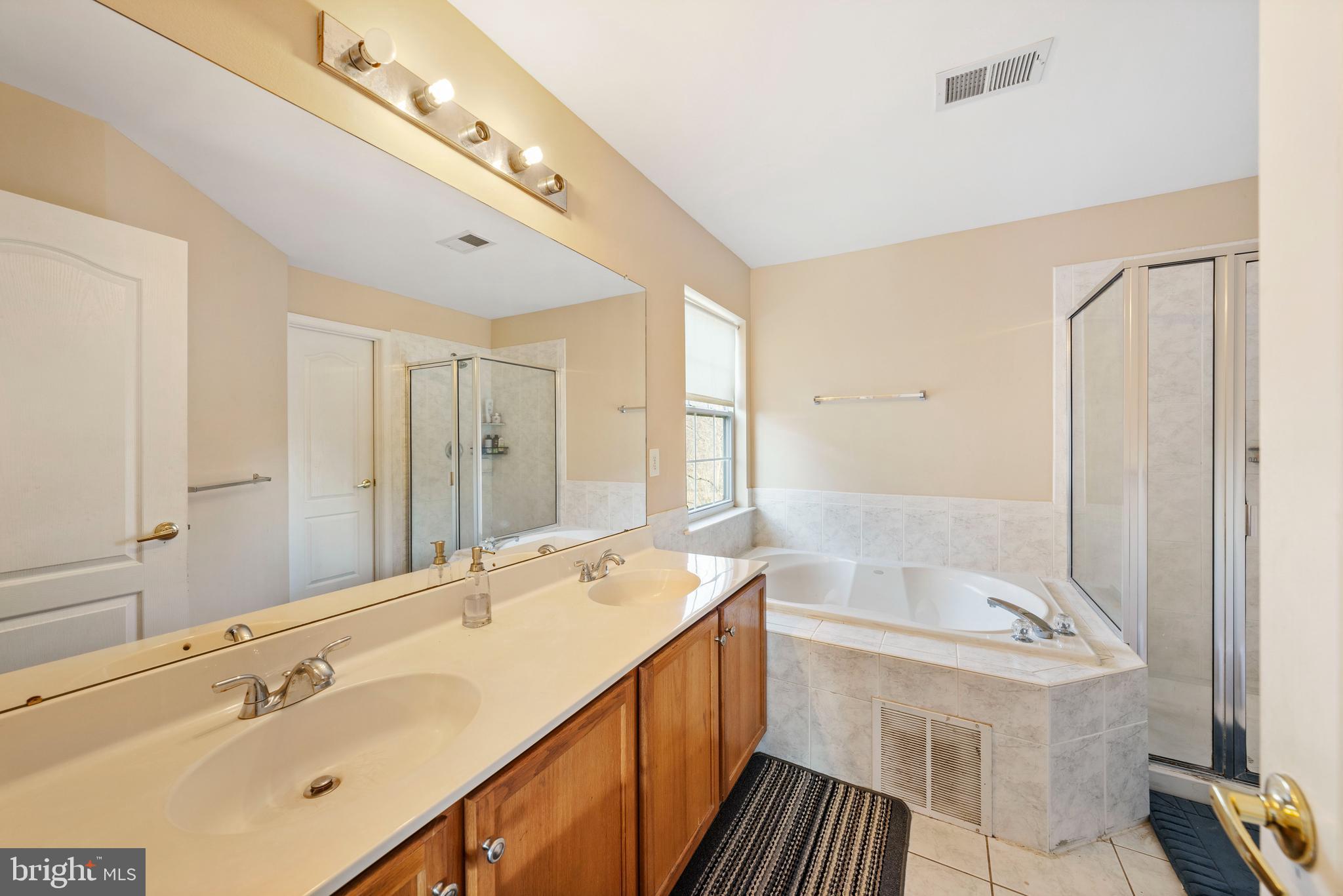 33 Cayuga Road Bordentown, NJ 08505 - Photo 13 of 30 a spacious bathroom with a shower sink and mirror