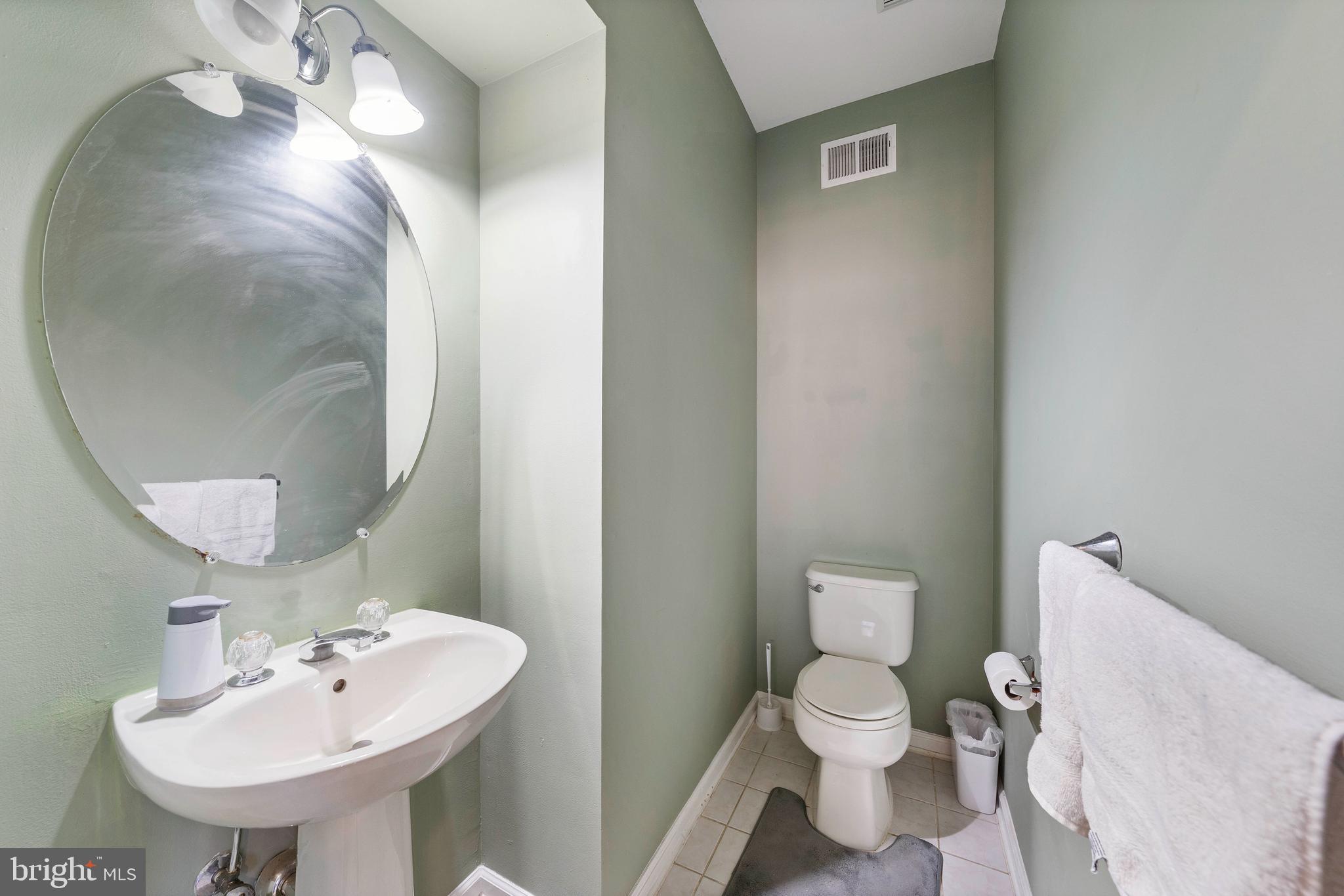 33 Cayuga Road Bordentown, NJ 08505 - Photo 10 of 30 a bathroom with a toilet a sink and a mirror