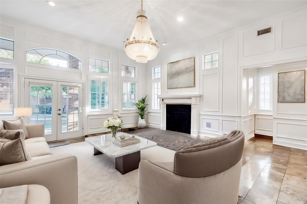 7204 Debbe Drive Dallas, TX 75252 - Photo 12 of 39 a living room with furniture a fireplace and a chandelier