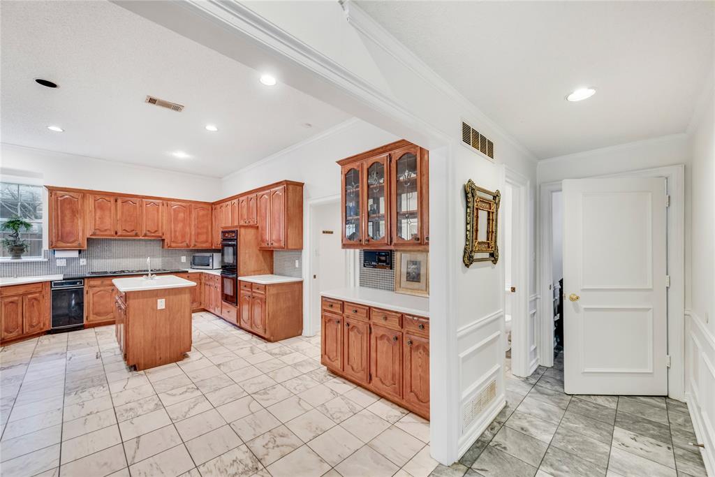 7204 Debbe Drive Dallas, TX 75252 - Photo 17 of 39 a kitchen with stainless steel appliances granite countertop a stove top oven a sink a counter space and cabinets