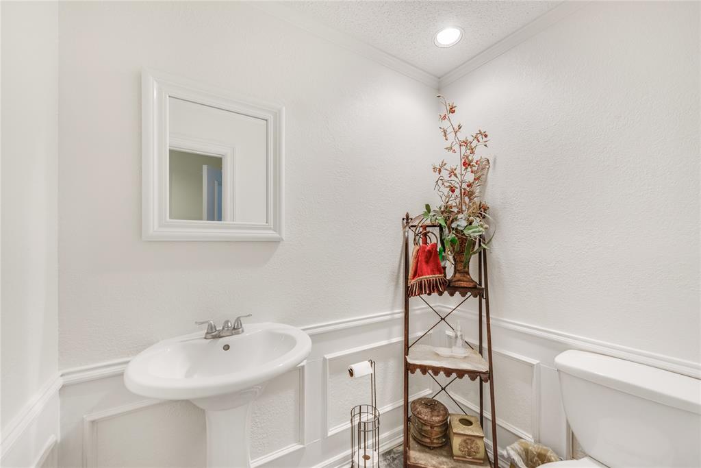 7204 Debbe Drive Dallas, TX 75252 - Photo 18 of 39 a bathroom with a sink mirror and vanity
