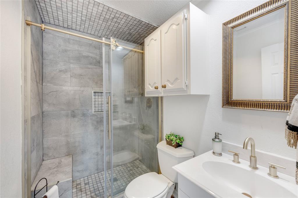 7204 Debbe Drive Dallas, TX 75252 - Photo 20 of 39 a bathroom with a sink toilet and shower