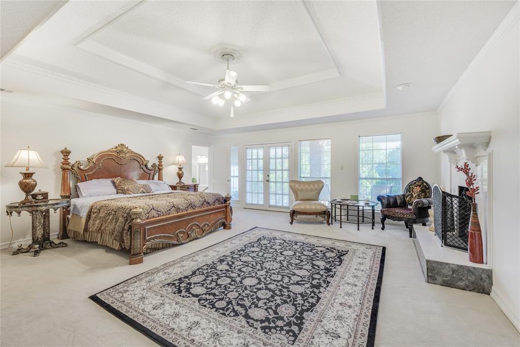 7204 Debbe Drive Dallas, TX 75252 - Photo 24 of 39 a spacious bedroom with a bed a table and chair