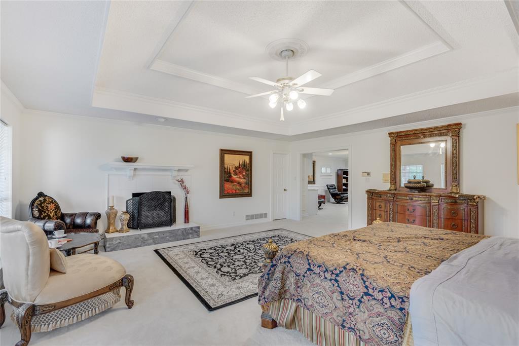 7204 Debbe Drive Dallas, TX 75252 - Photo 25 of 39 a bedroom with a large bed a couch and dresser