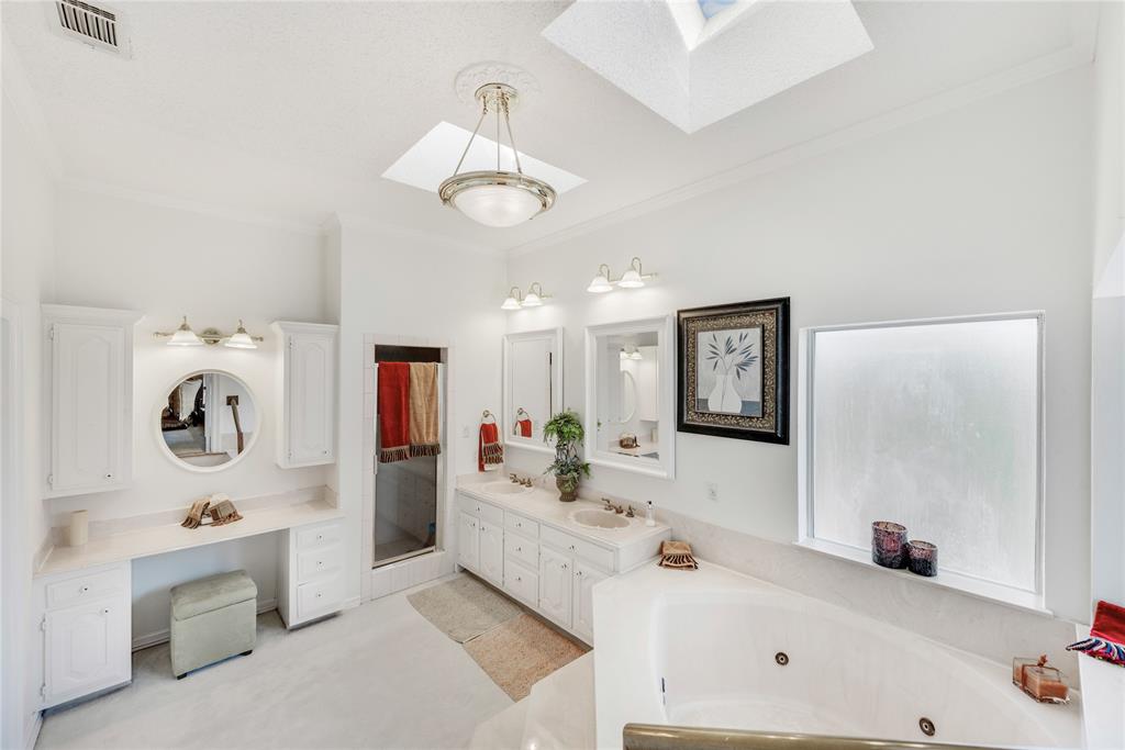 7204 Debbe Drive Dallas, TX 75252 - Photo 26 of 39 a bathroom with a tub sink and mirror