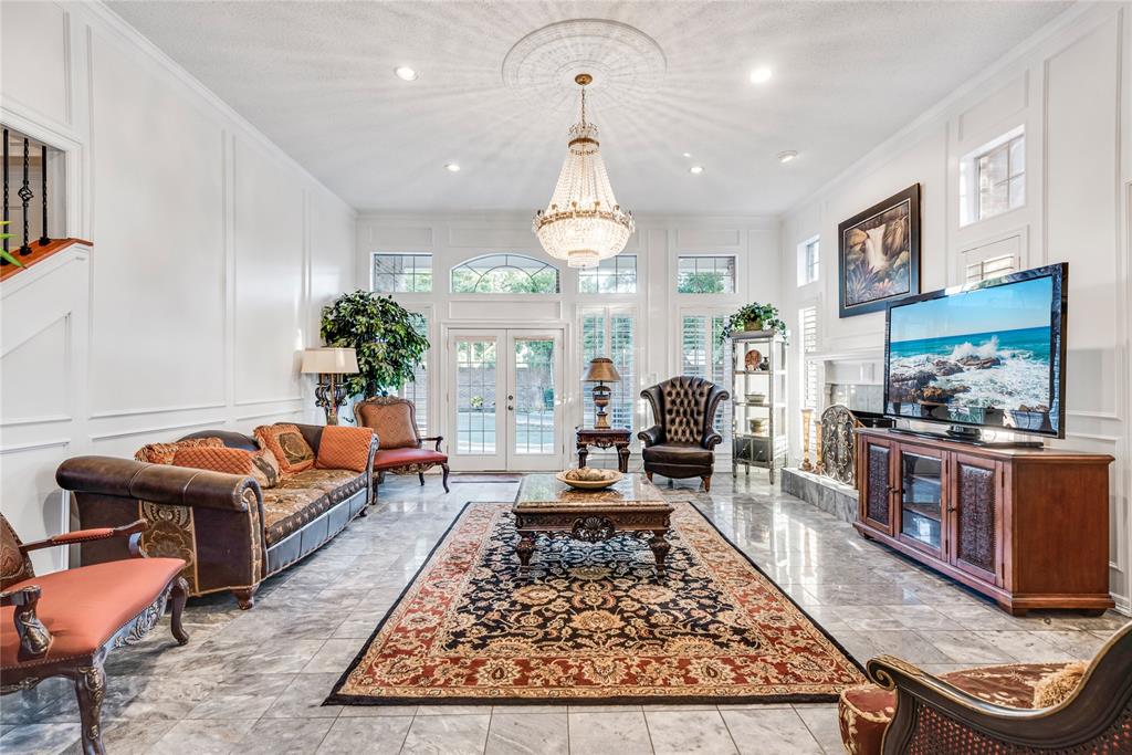 7204 Debbe Drive Dallas, TX 75252 - Photo 6 of 39 a living room with furniture and a chandelier