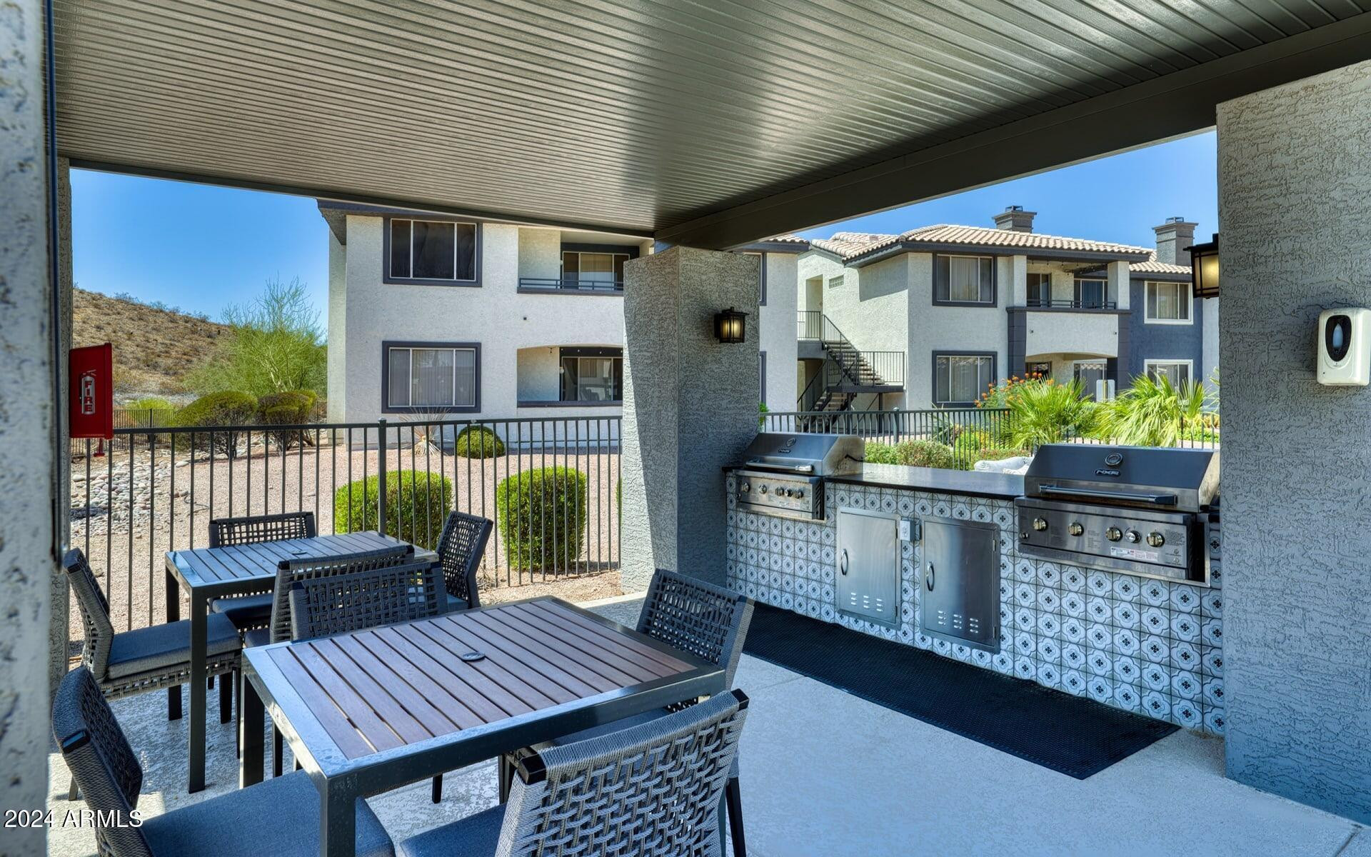 3625 East Ray Road, Unit 1 Phoenix, AZ 85044 - Photo 18 of 29 a balcony view with couple of chairs and a table