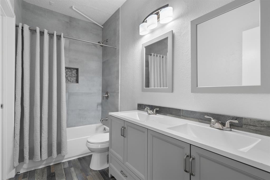 5310 Keller Springs Road, Unit 626 Dallas, TX 75248 - Photo 9 of 13 a bathroom with a sink toilet double vanity and shower