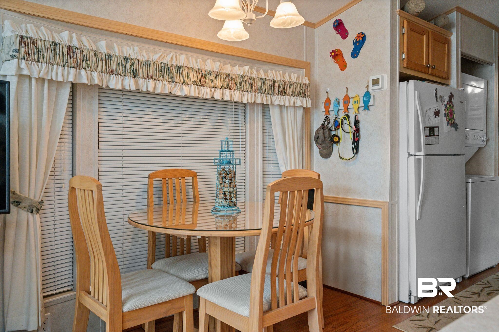 24711 County Road 20, Unit A11 Elberta, AL 36530 - Photo 10 of 35 Dining space with a chandelier, wood finished floors, and washer / clothes dryer