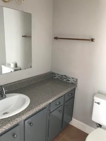 a kitchen with granite countertop a sink and cabinets