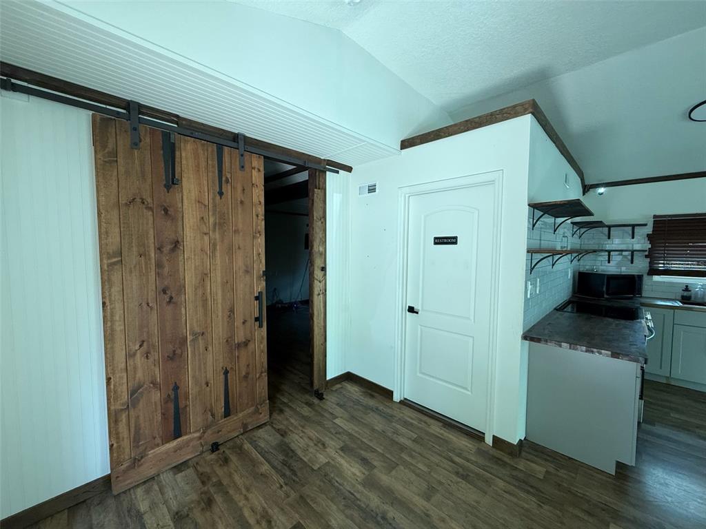 18312 Hollister Road Orlando, FL 32820 - Photo 4 of 10 a view of a refrigerator in kitchen and wooden floor