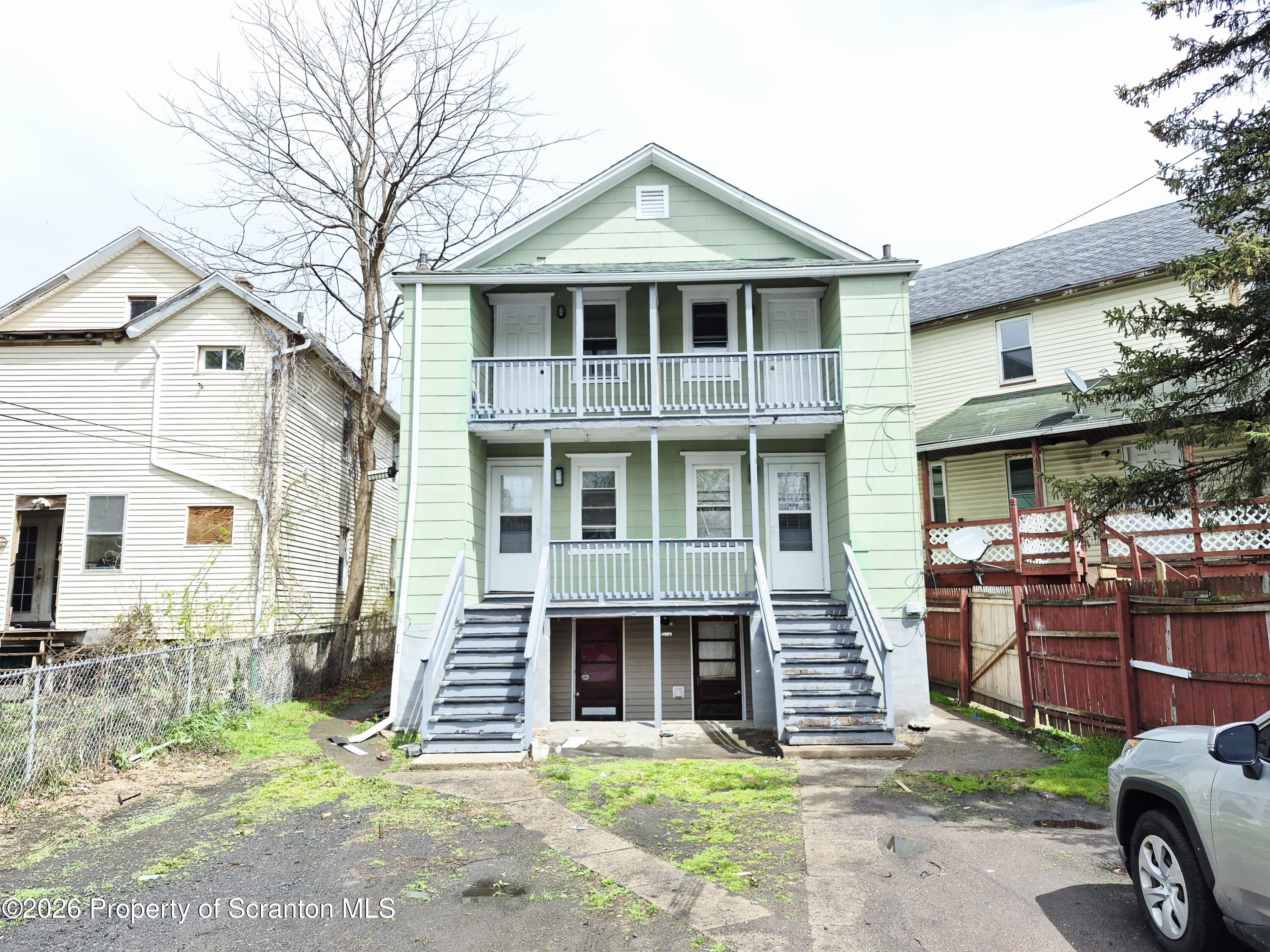 68 Green Place, Unit 1 Scranton, PA 18509 - Photo 1 of 15 a front view of a house with garden