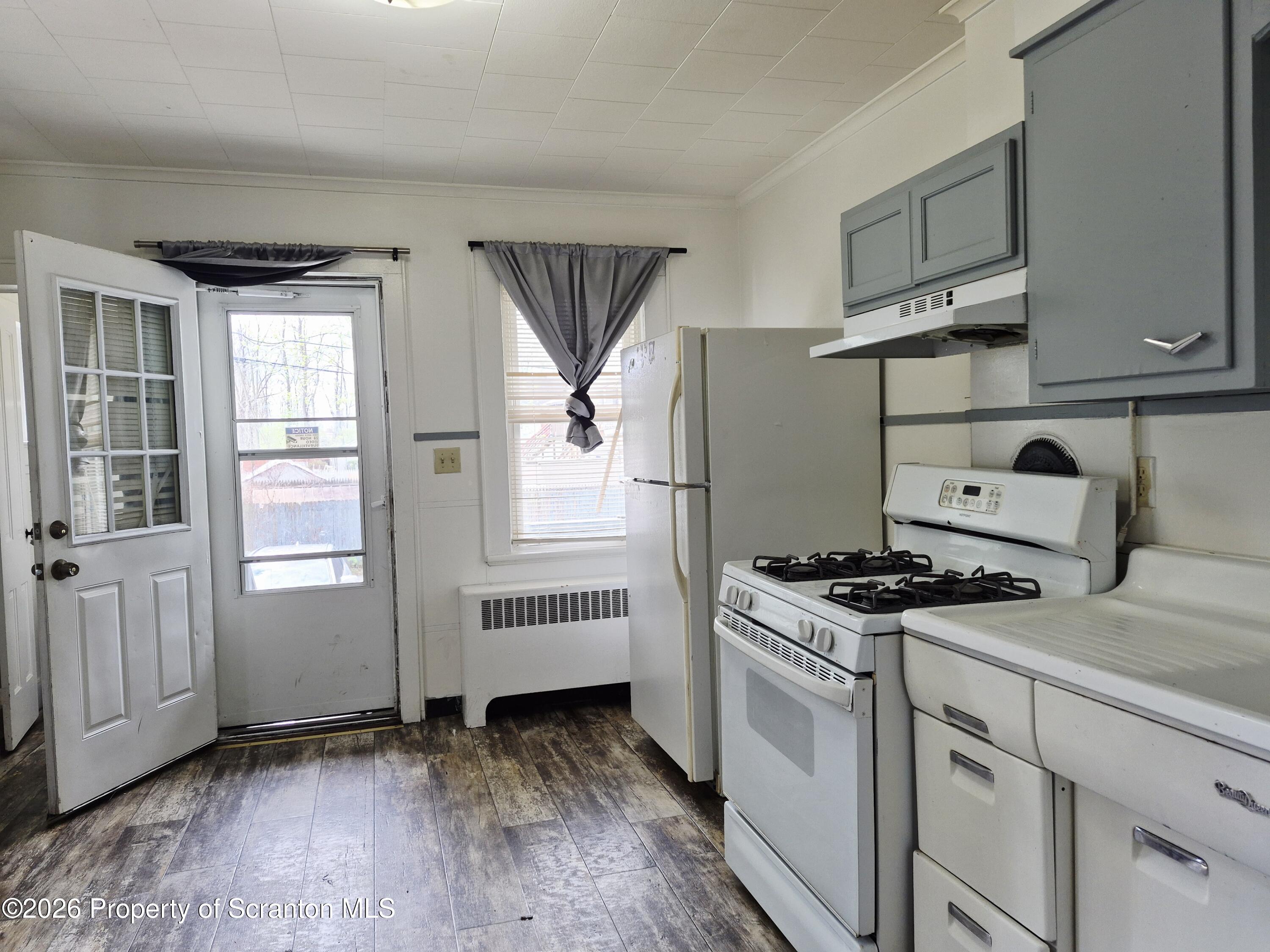 68 Green Place, Unit 1 Scranton, PA 18509 - Photo 3 of 15 a kitchen with granite countertop white cabinets and white appliances