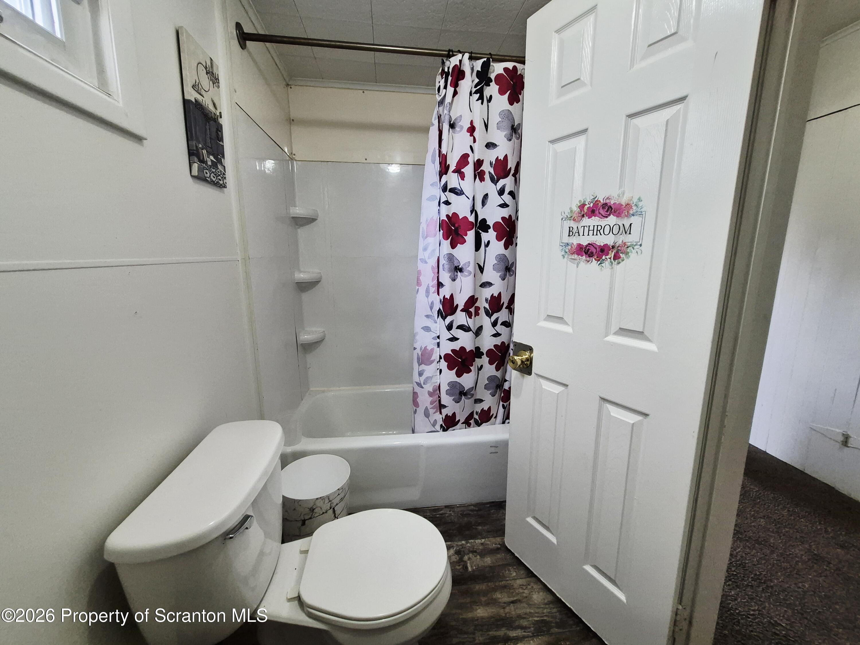 68 Green Place, Unit 1 Scranton, PA 18509 - Photo 4 of 15 a bathroom with a toilet and shower curtain