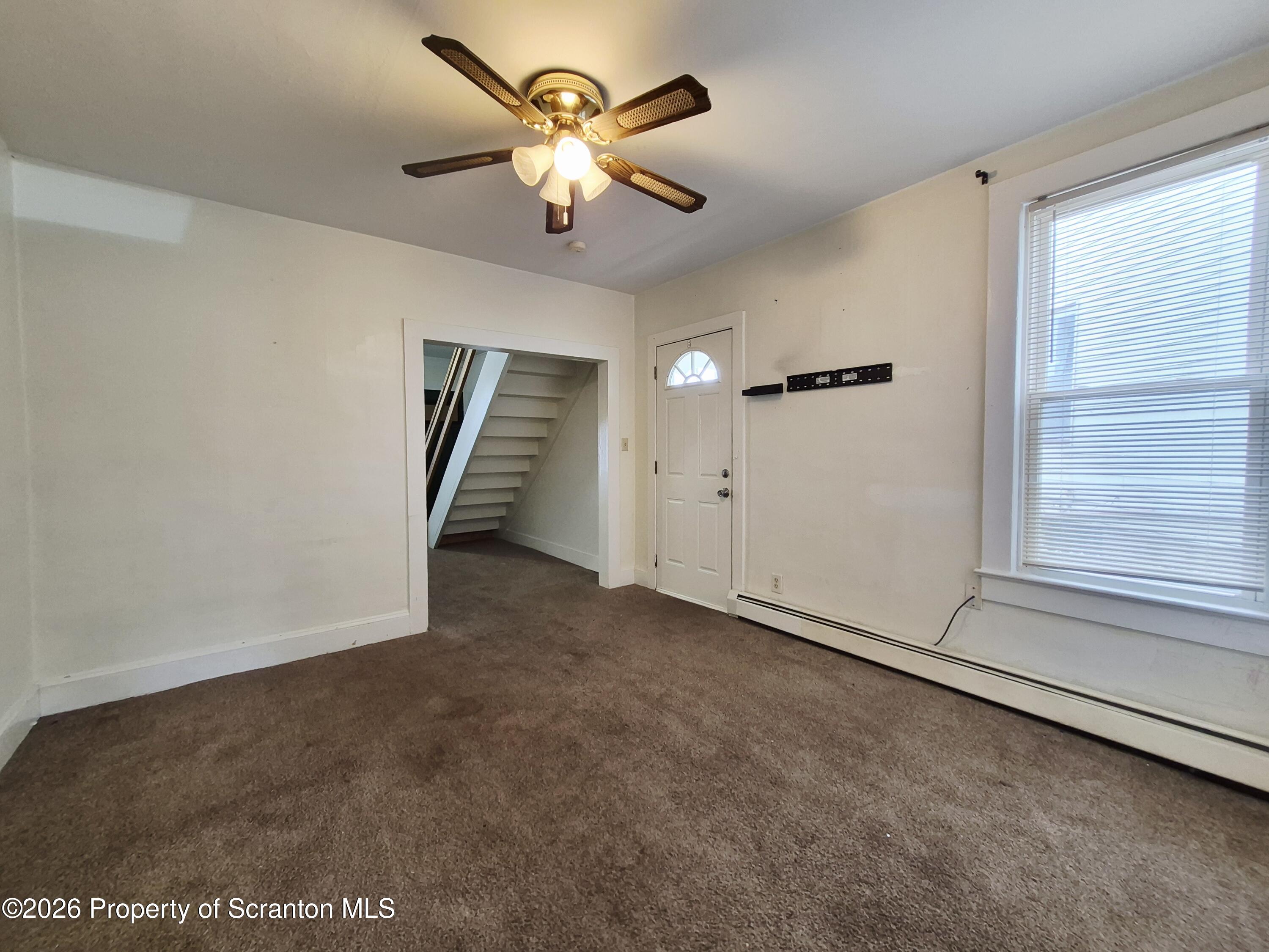68 Green Place, Unit 1 Scranton, PA 18509 - Photo 6 of 15 an empty room with a empty space and a ceiling fan