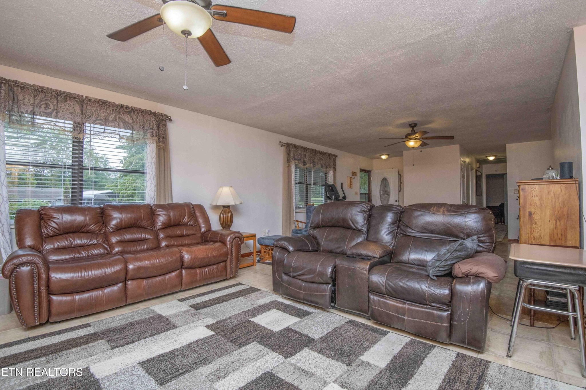 2206 Rambling Road Knoxville, TN 37912 - Photo 11 of 47 a large living room with couches cabinet and a chandelier