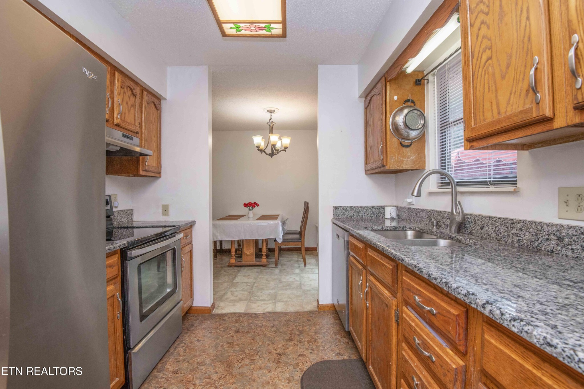 2206 Rambling Road Knoxville, TN 37912 - Photo 32 of 47 a kitchen with stainless steel appliances granite countertop a stove a sink and a microwave