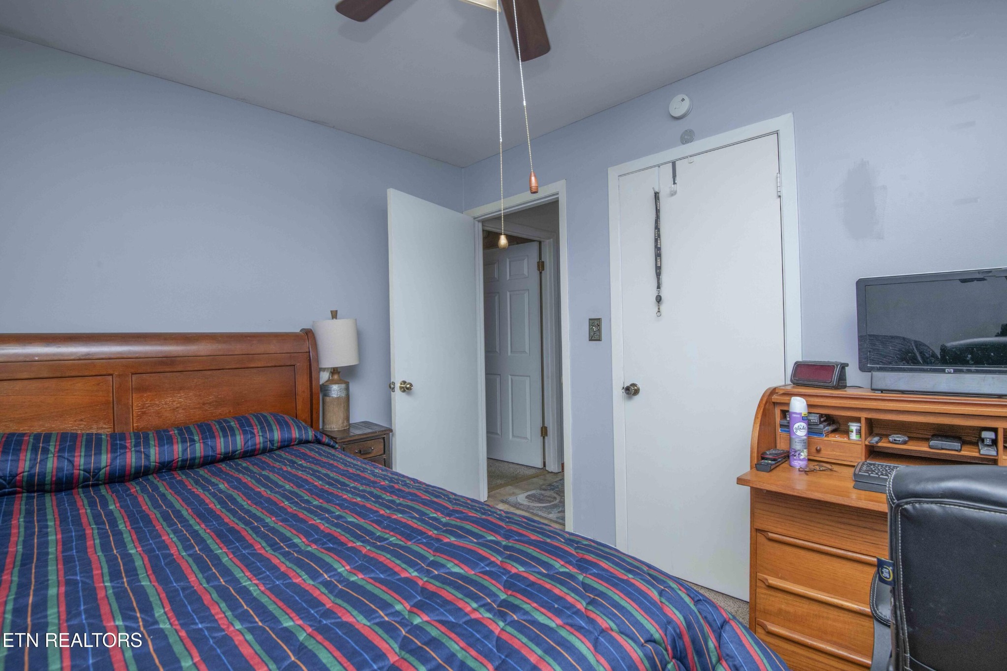 2206 Rambling Road Knoxville, TN 37912 - Photo 39 of 47 a bedroom with a bed and a flat tv screen on a dresser